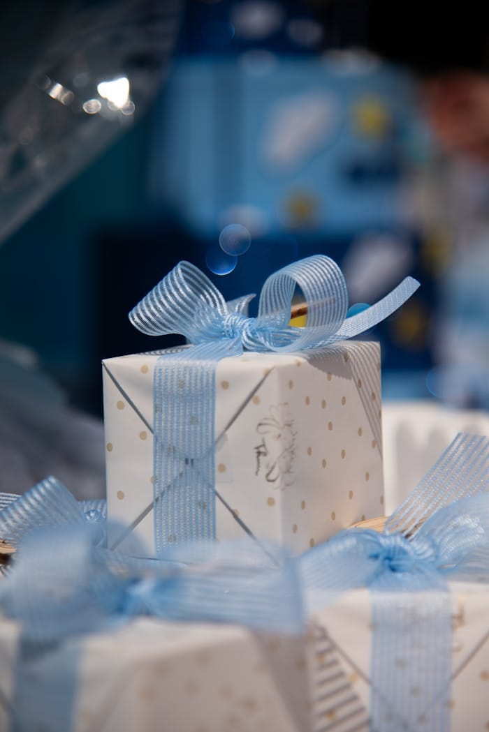 Services Elegant gift box with blue ribbon and polka dots, perfect for celebrations.